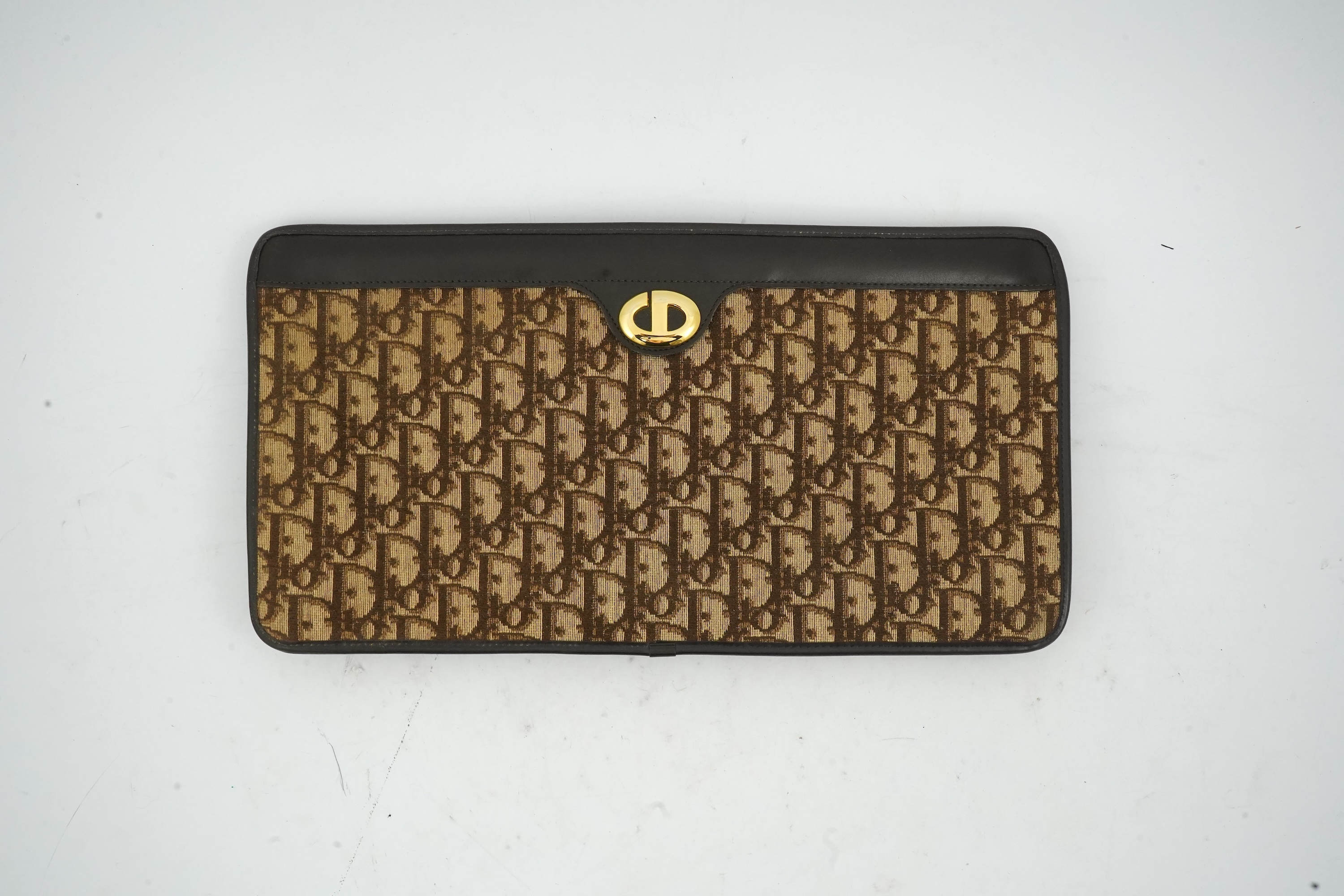 A vintage Dior brown cloth and leather trim monogram clutch bag